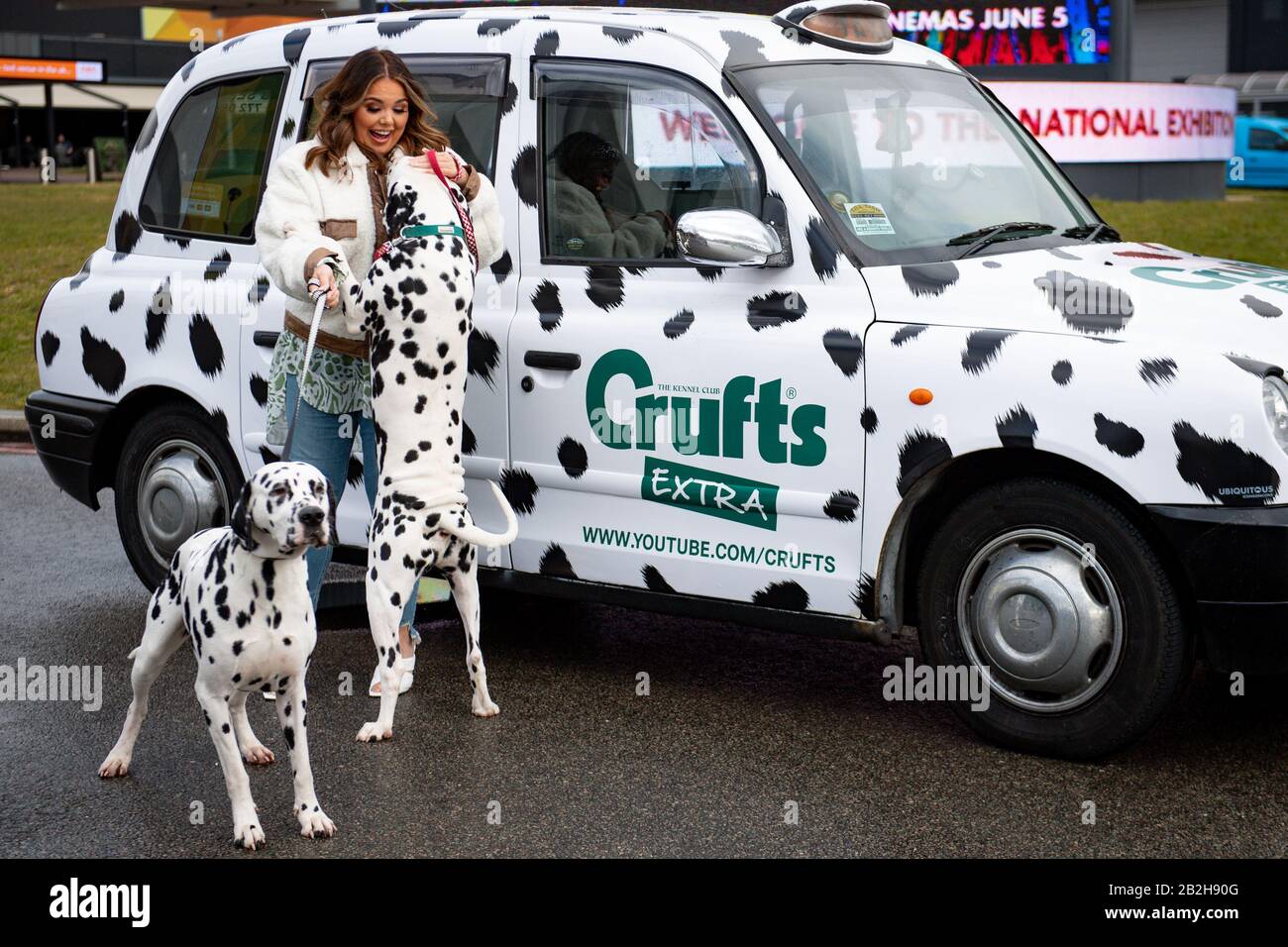 Scarlett Moffatt holds Dalmatians by a Crufts themed taxi at the Birmingham National Exhibition Centre (NEC), Birmingham, to launch the forthcoming Crufts Dog Show. PA Photo. Picture date: Tuesday March 3, 2020. Photo credit should read: Jacob King/PA Wire Stock Photo