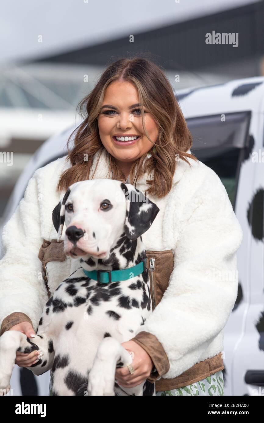 Birmingham NEC, UK. 3rd Mar, 2020. Scarlett Moffatt, star of Gogglebox and I'm a Celebrity, arrives in style in a Dalmation themed taxi at Crufts 2020, NEC Birmingham, to start preparations for the new Crufts Extra Youtube show. Crufts 2020 runs from 5th to 8th March. Credit: Peter Lopeman/Alamy Live News Stock Photo