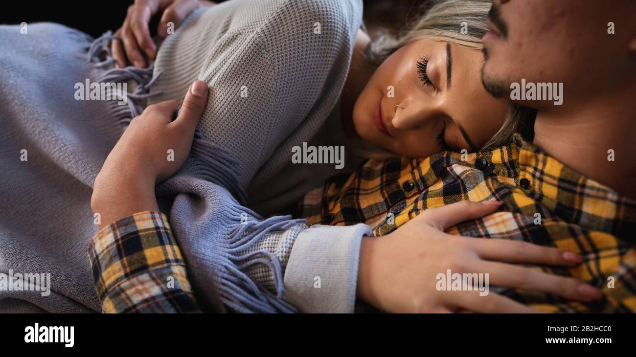 Young couple sleeping together on the sofa Stock Photo