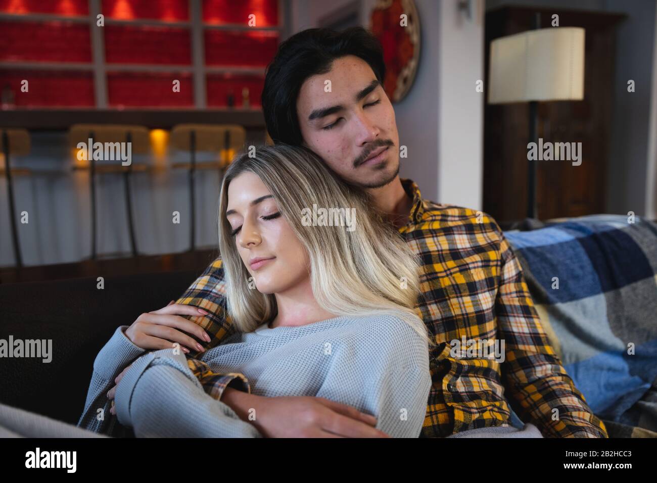 Young couple sleeping together on the sofa Stock Photo