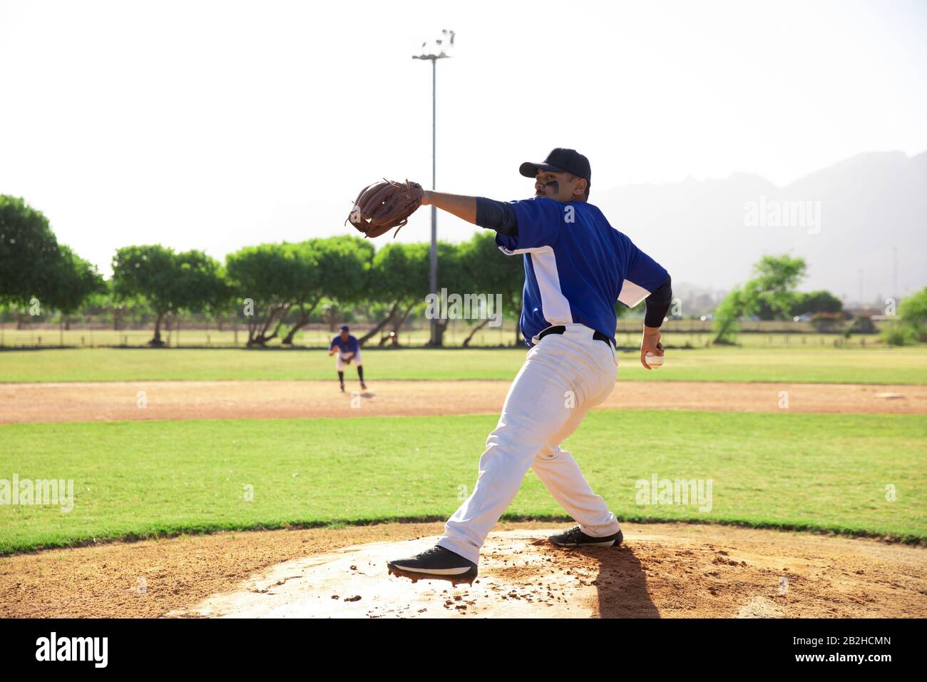 Baseball player throwing a ball during a match Stock Photo Alamy