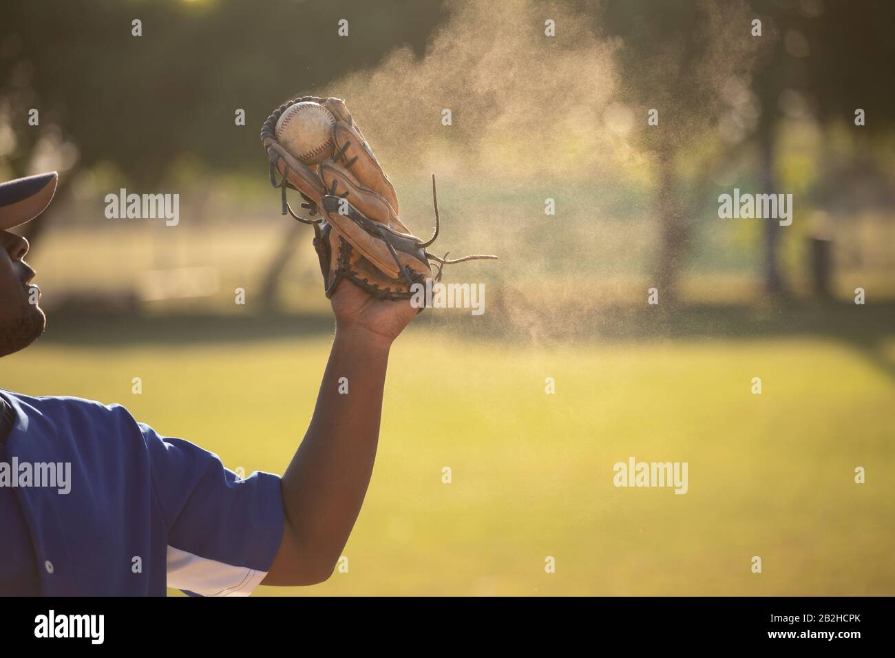 Baseball player catching a ball during a match Stock Photo