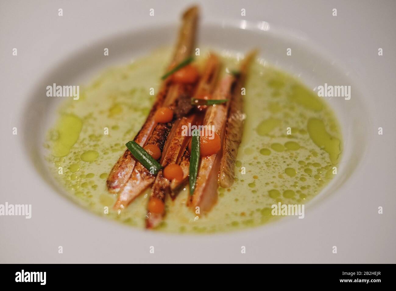 Red mullet, garnishes with carrot, sea fennel and bathes in dill oil Venissa Restaurant, Food and dining on the island of  Mazzorbo, Venice, Italy Stock Photo