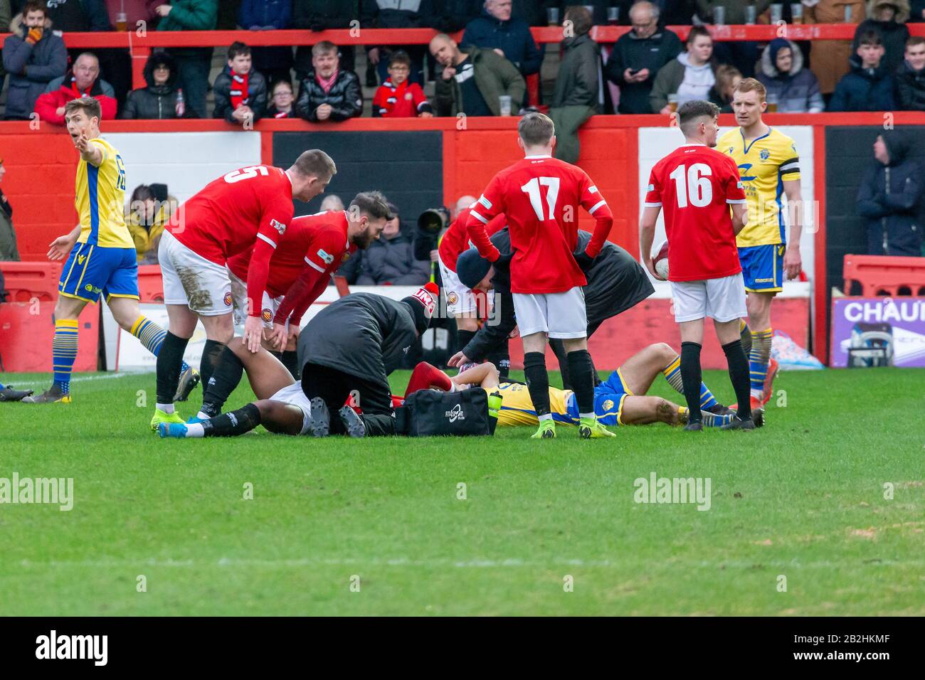 Warrington's Tom Warren clashes heads with an FCUM player and assistance is given as both players lay on the ground Stock Photo