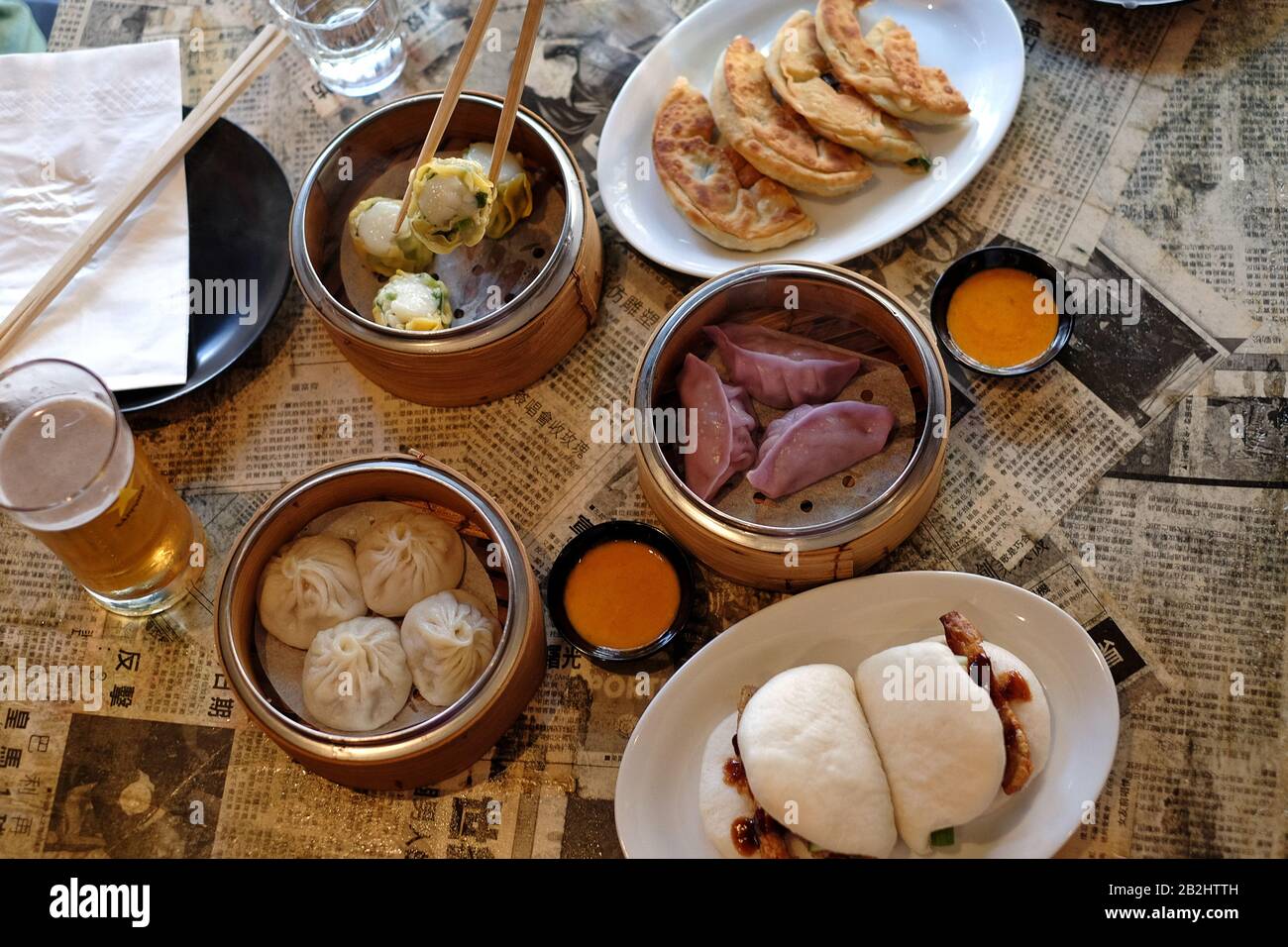 Dim Stick Using chop sticks to serve hot Dim Sum from a bamboo steamer. Casual ...