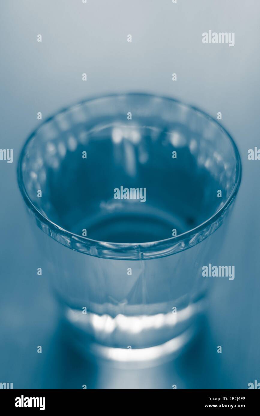 Full glass of water. Blue tone. Selective focus. Stock Photo