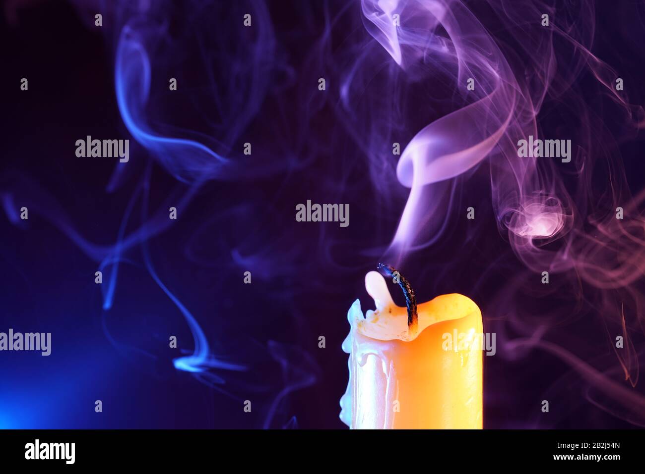 Candle after blowing out the flame photographed with colorful flashes