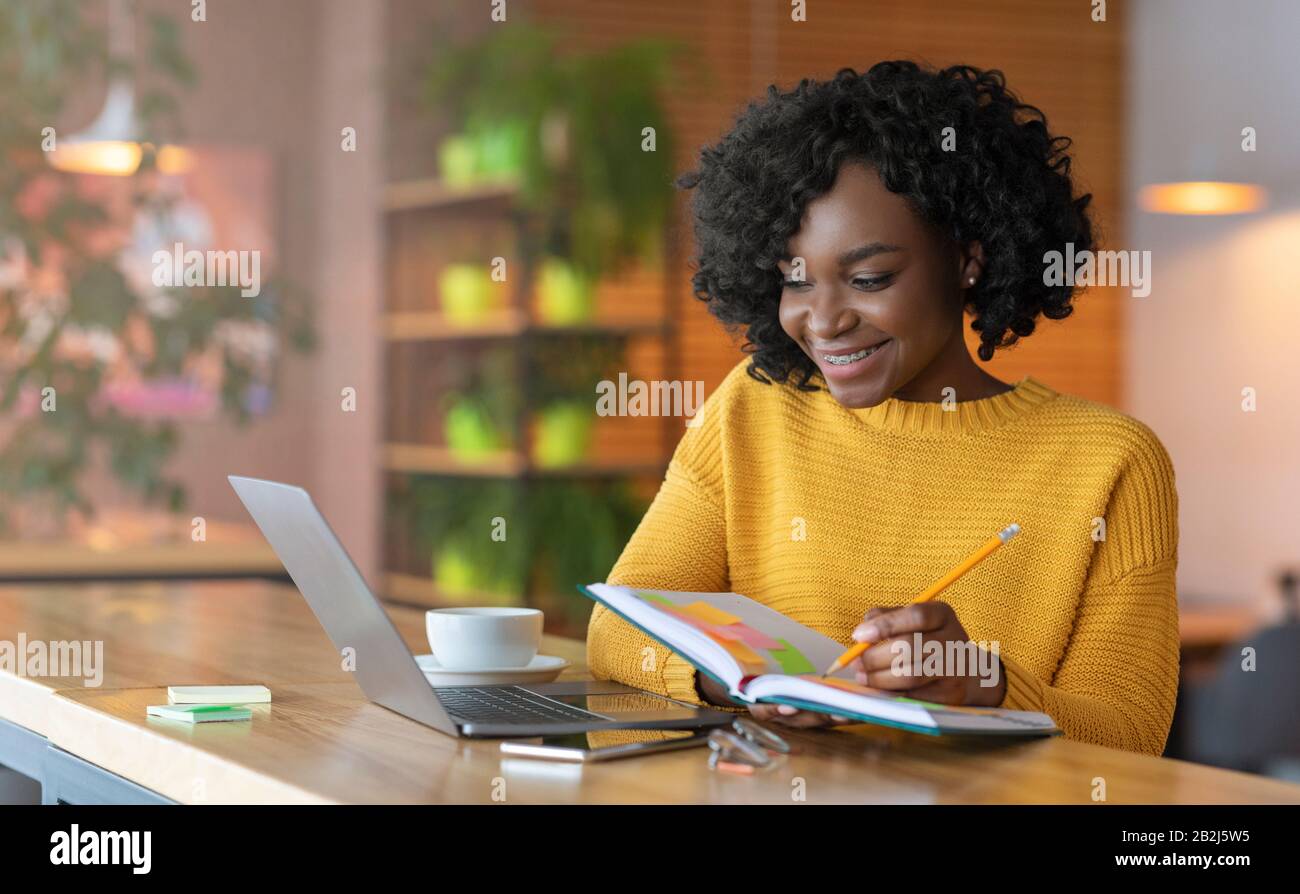 Enthusiastic student girl looking for job online, using laptop Stock Photo
