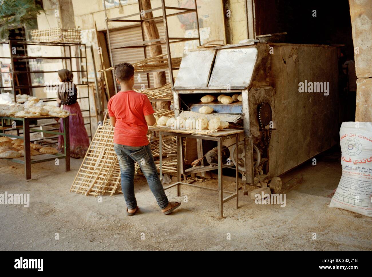 Travel Photography - Bread making street stall in Islamic Cairo district of the city of Cairo in Egypt in North Africa Middle East Stock Photo