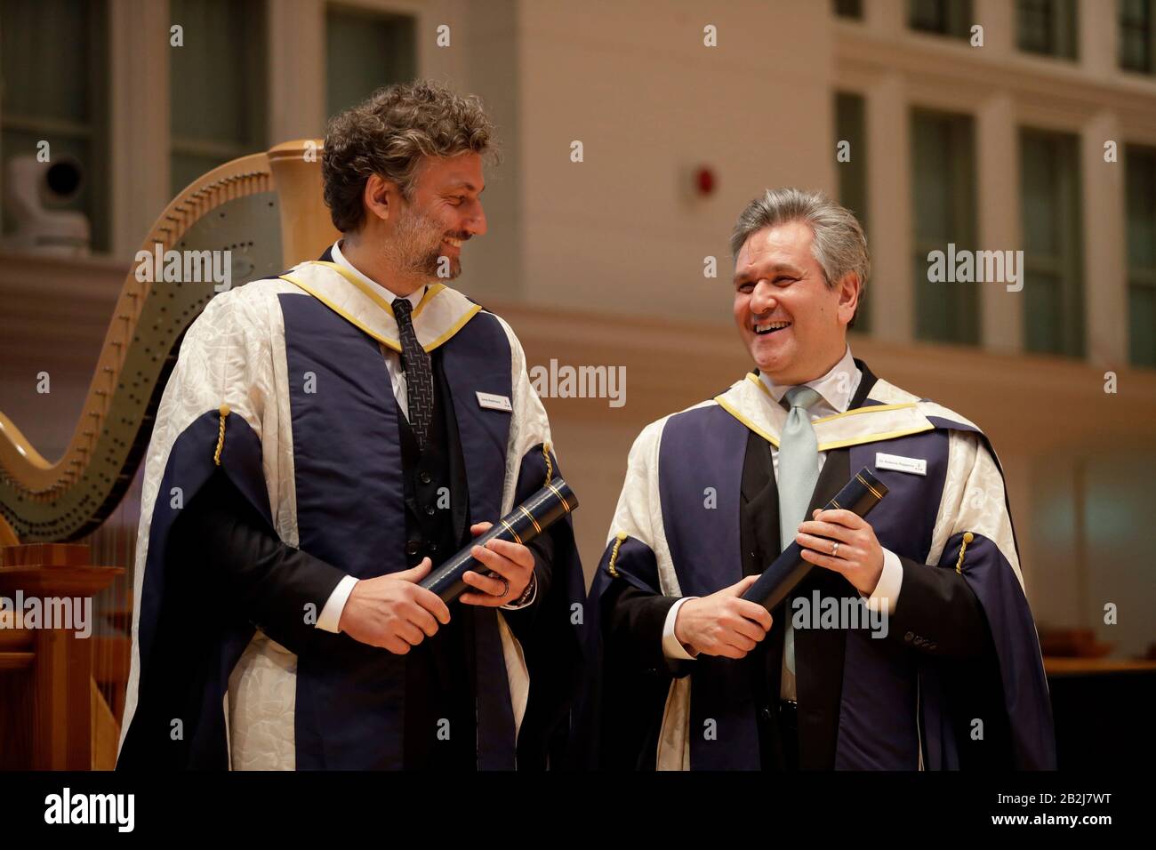 German operatic tenor Jonas Kaufmann, (left) and English-Italian conductor and pianist Sir Antonio Pappano stand together on stage after being presented with their honorary Doctor of Music awards by the Prince of Wales at the Royal College of Music's annual awards in London. Stock Photo