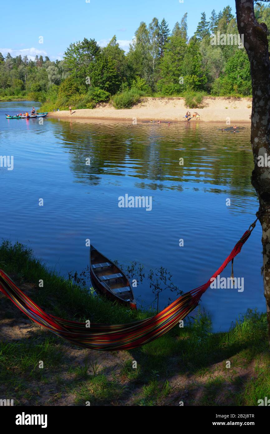 Rest on the river with boats on a sunny day Stock Photo
