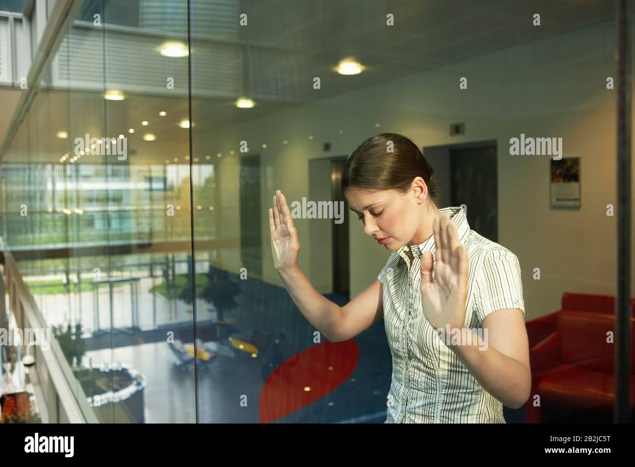 Woman Behind Glass Wall in office Stock Photo Alamy
