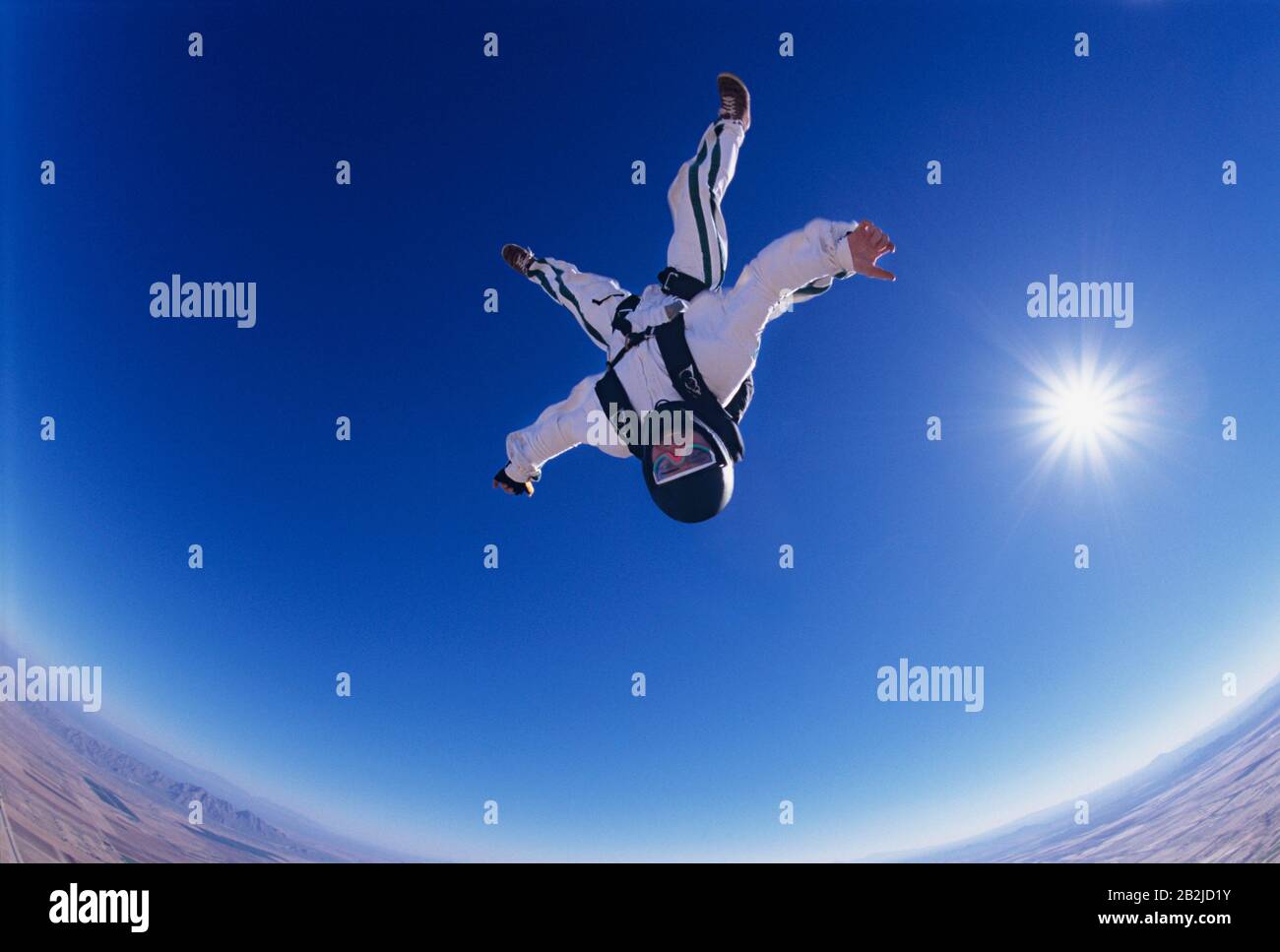 Skydiver free falling upside down portrait view from below Stock Photo