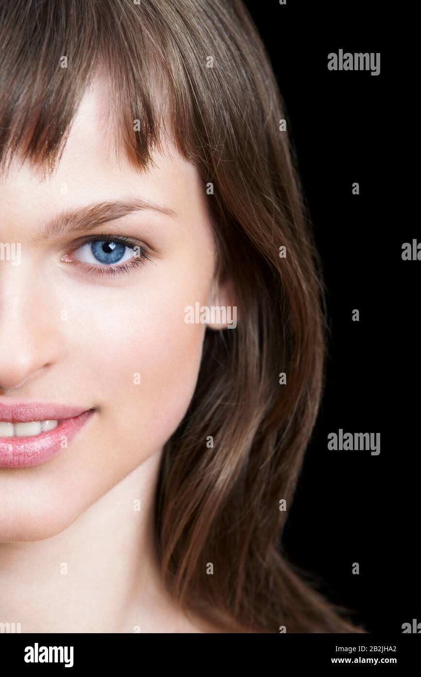 Young Brunette Woman With Blue Eyes Stock Photo - Alamy