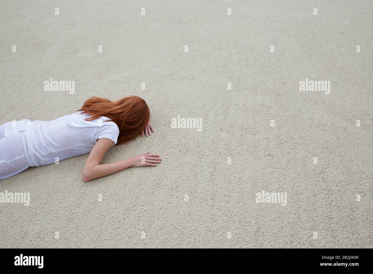 Woman Lying Face Down on Beach Stock Photo