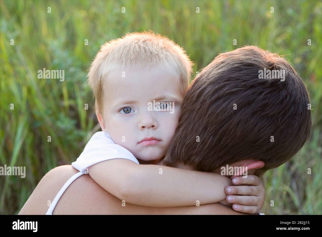 Little Boy Hugging His Mother Stock Photo