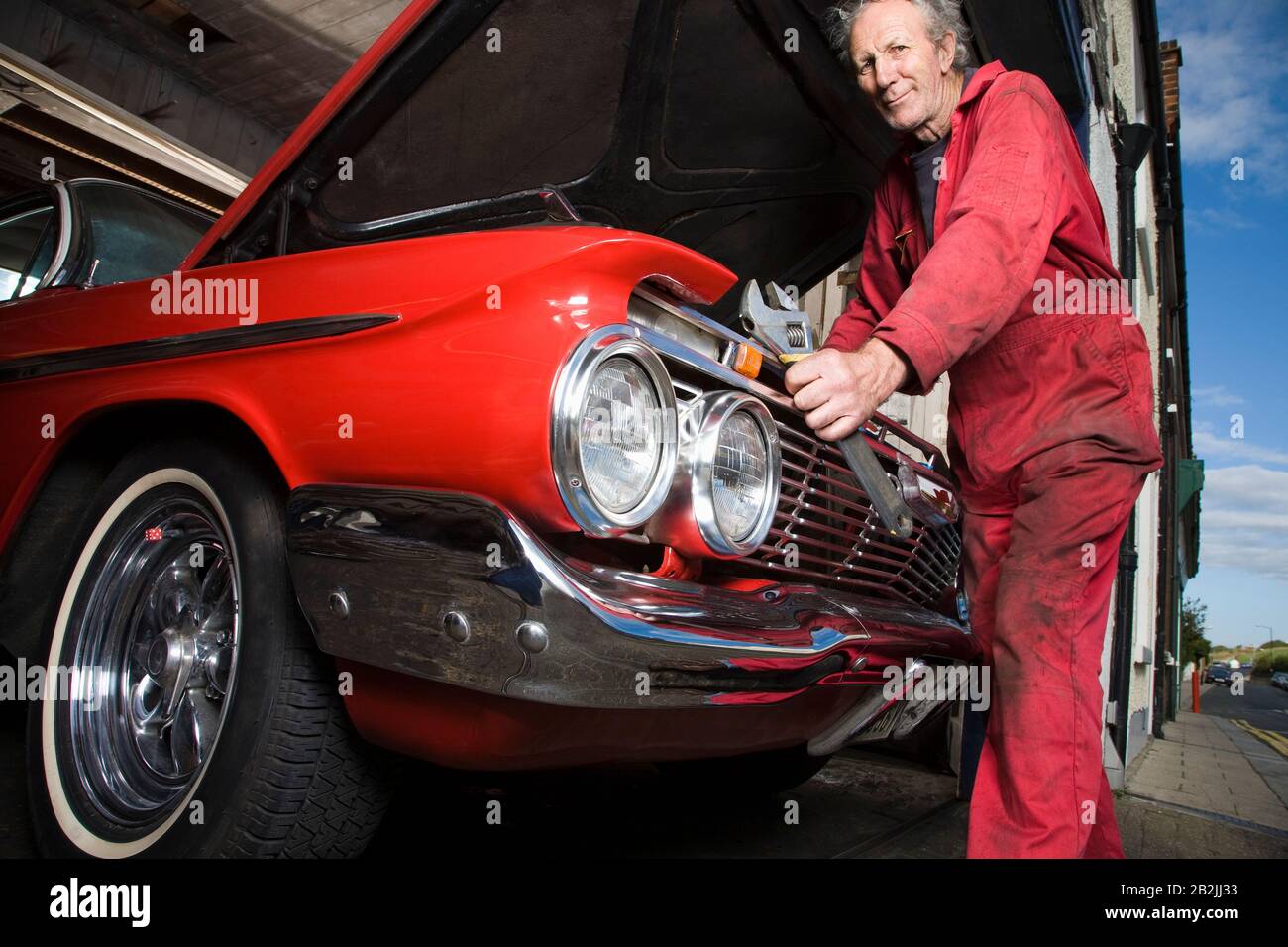 Mechanic Working on Engine of a Vintage Car Stock Photo Alamy