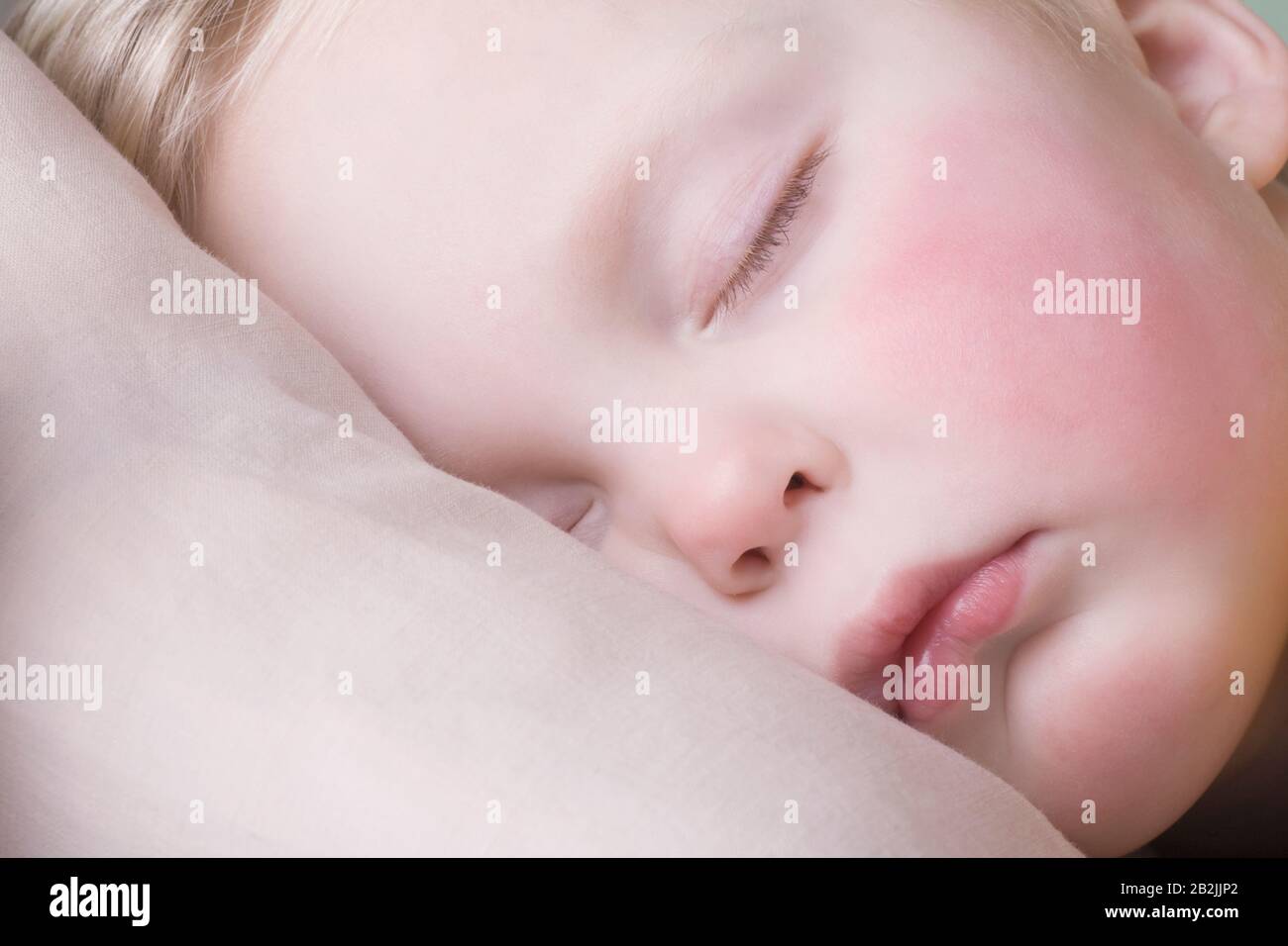 Baby boy lies sleeping Stock Photo Alamy