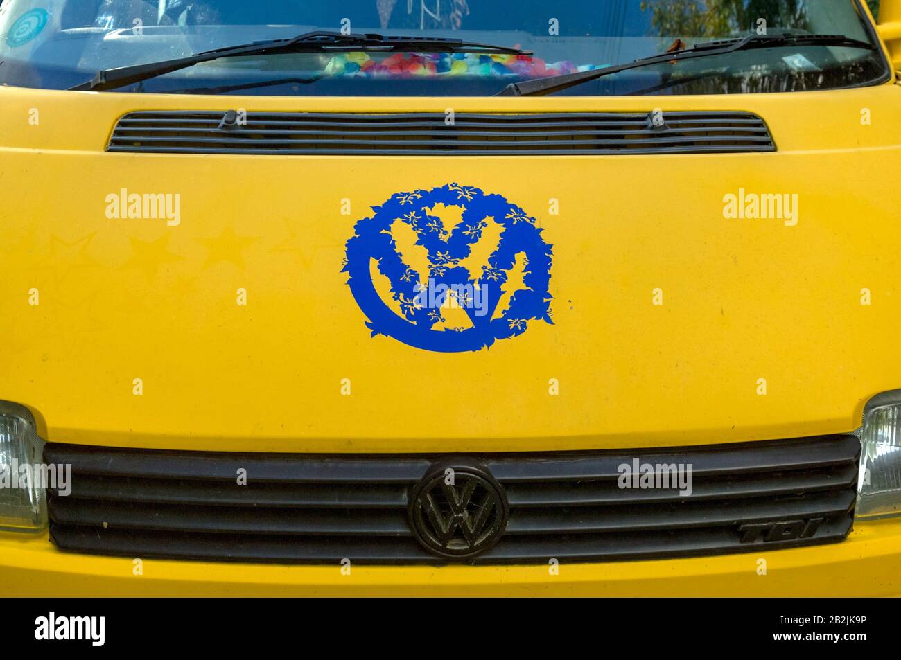 Closeup view of the front of a yellow VW camper van Stock Photo