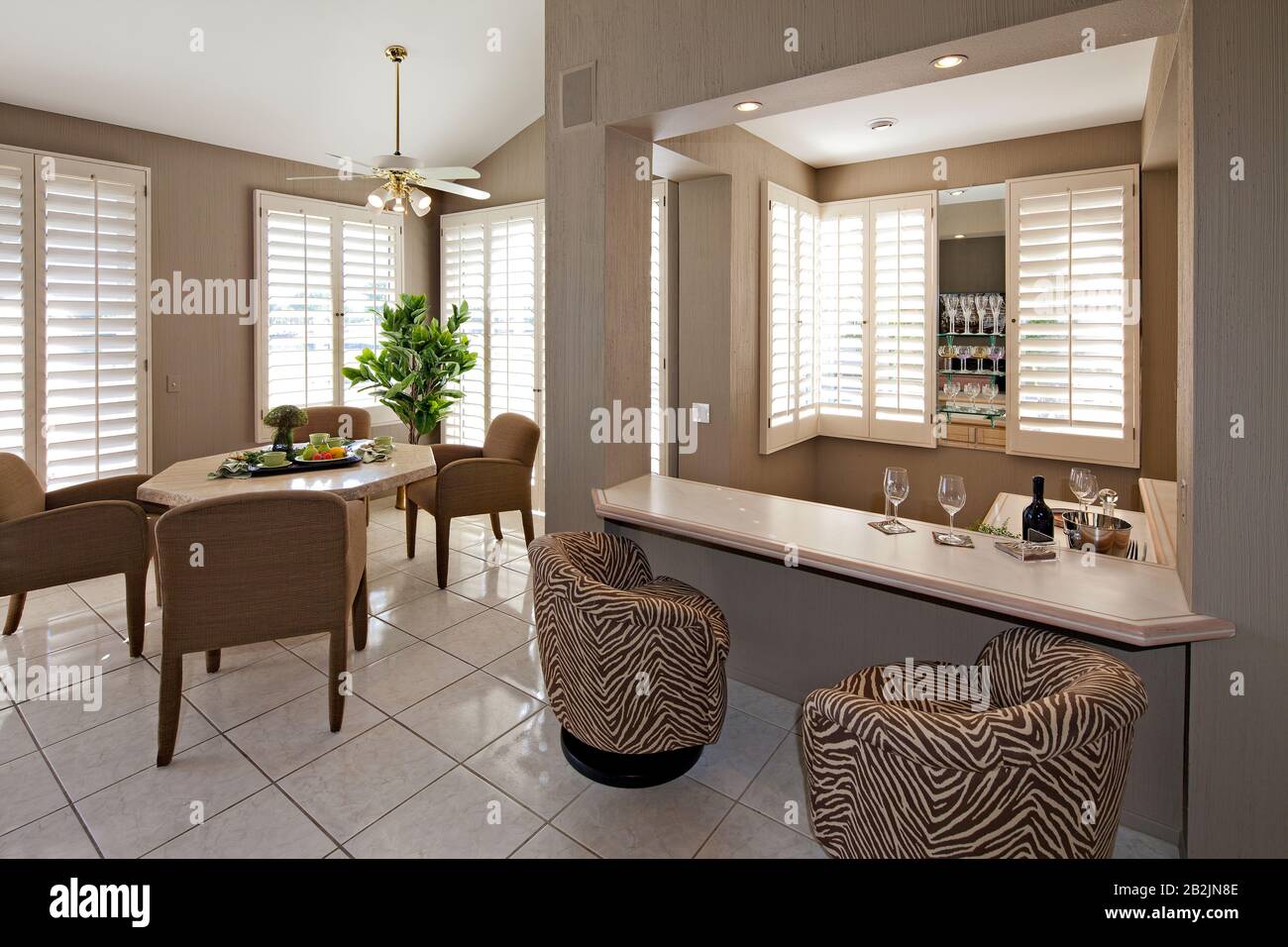 Bar counter with dining table and chair in luxurious villa Stock Photo -  Alamy