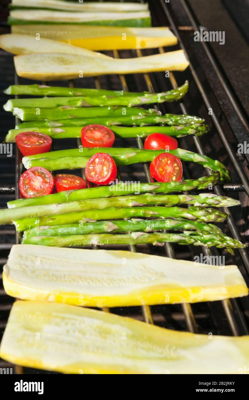 Cucumber, tomatoes and asparagus on grill Stock Photo