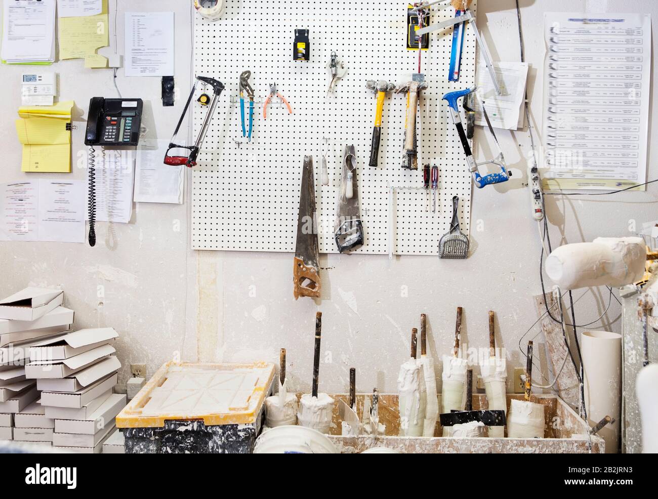 Assorted workshop tools on a pegboard Stock Photo