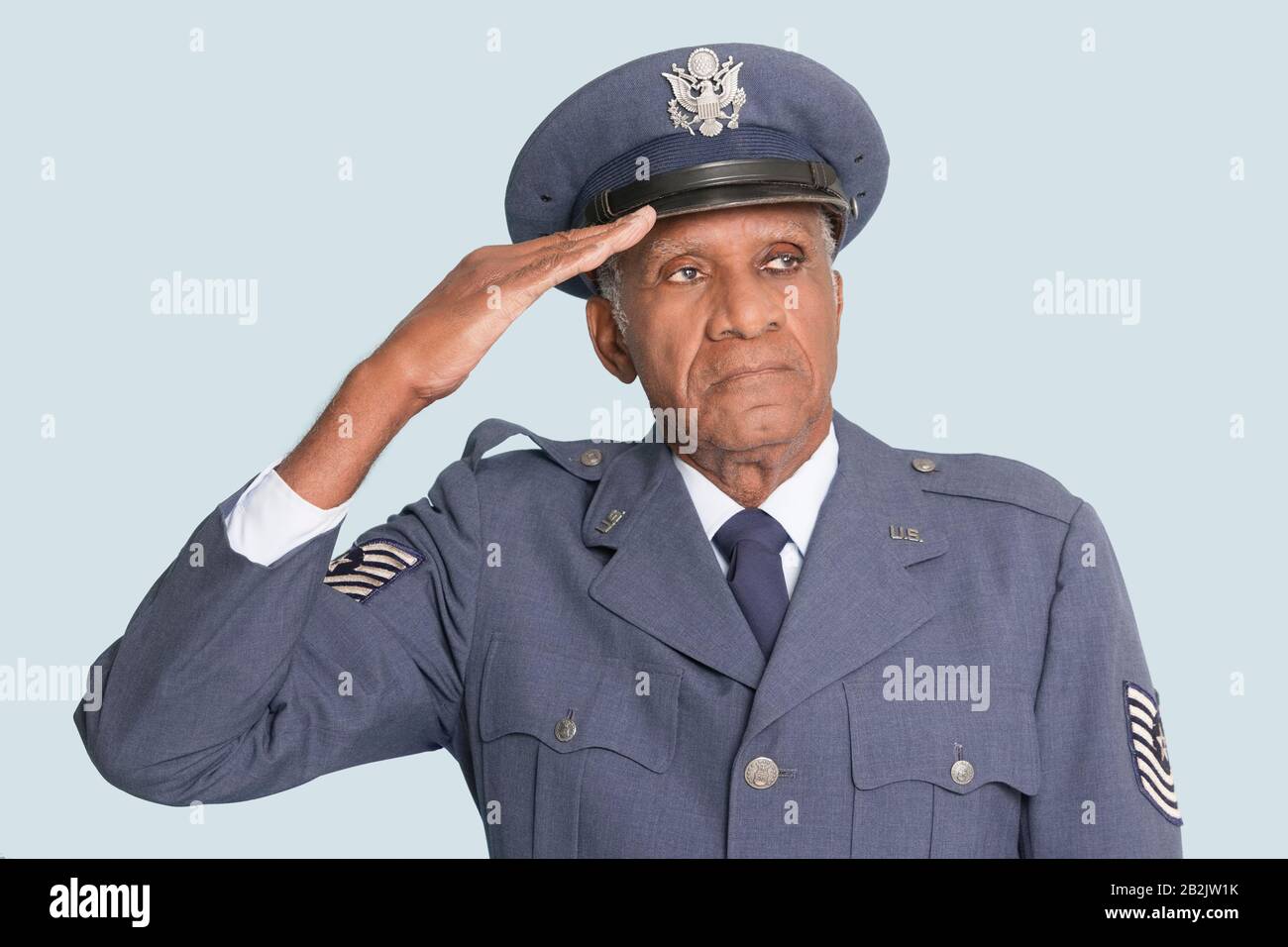 Portrait of a senior male US Air Force officer saluting over light blue  background Stock Photo - Alamy