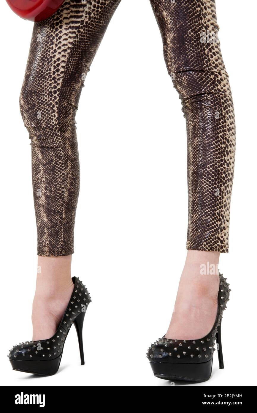 Low section of female legs with high heels over white background Stock