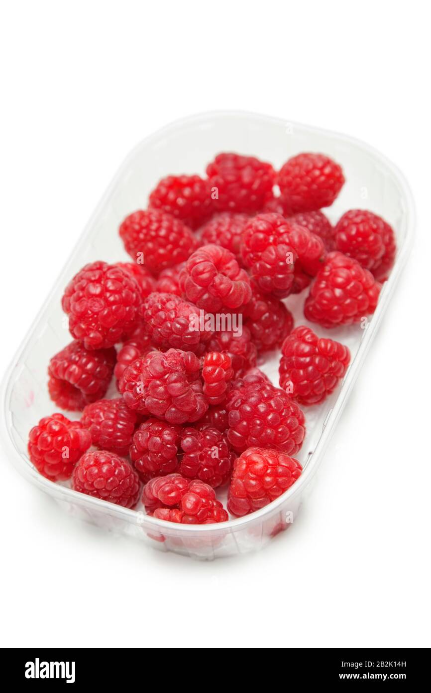 Fresh raspberries in a container against white background Stock Photo
