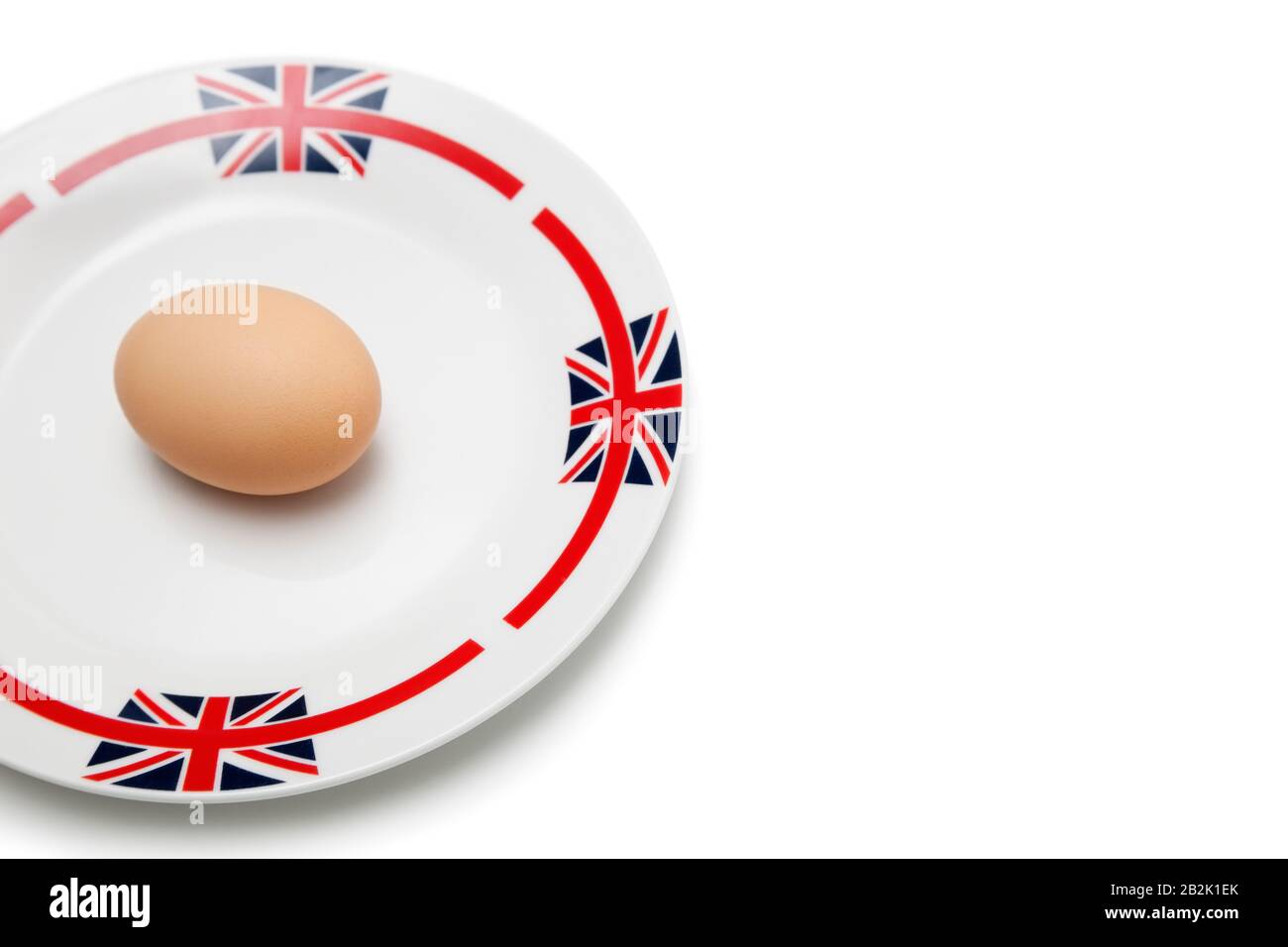 Brown egg in plate over white background Stock Photo