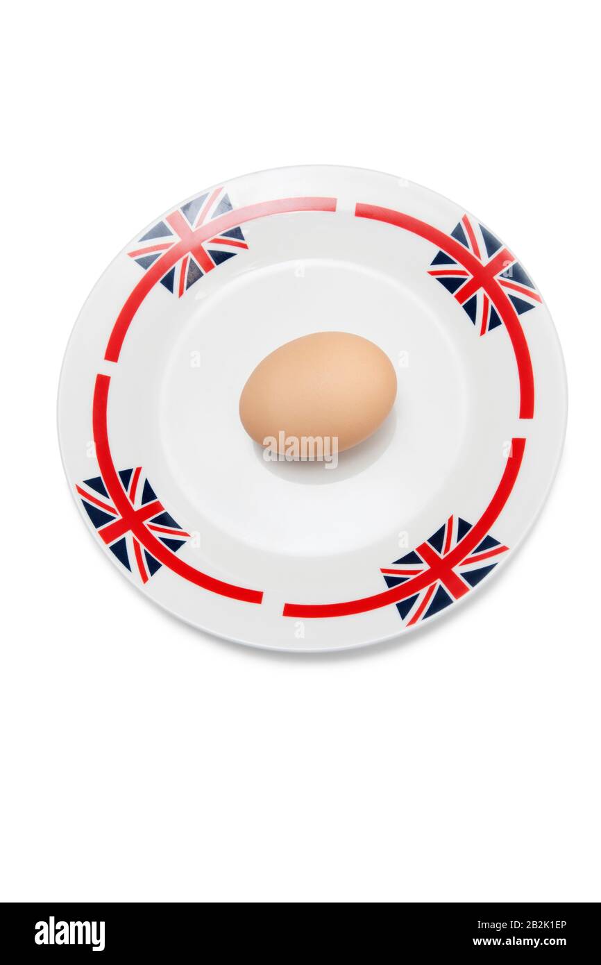 Brown egg in plate against white background Stock Photo