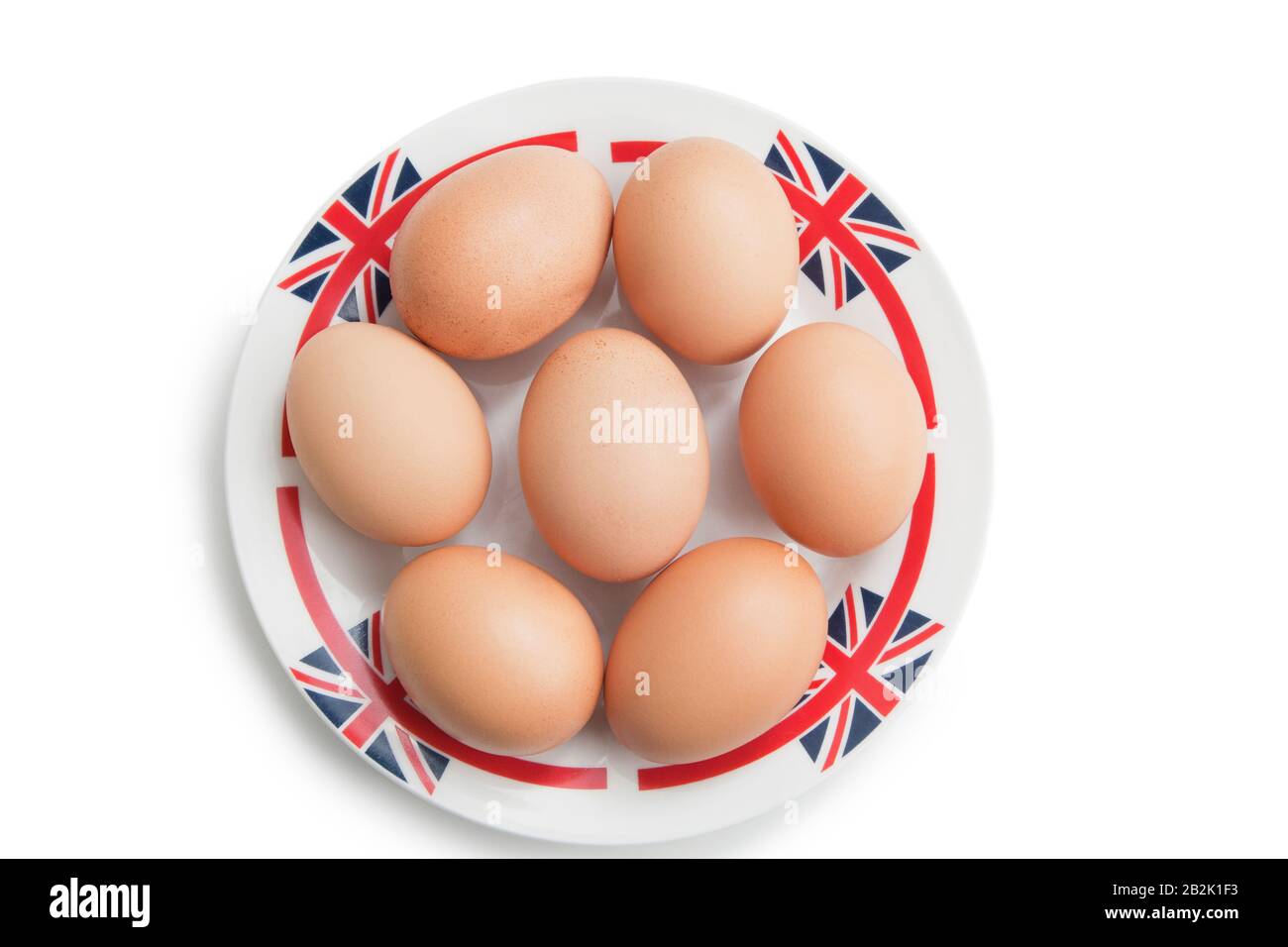Brown eggs in plate over white background Stock Photo