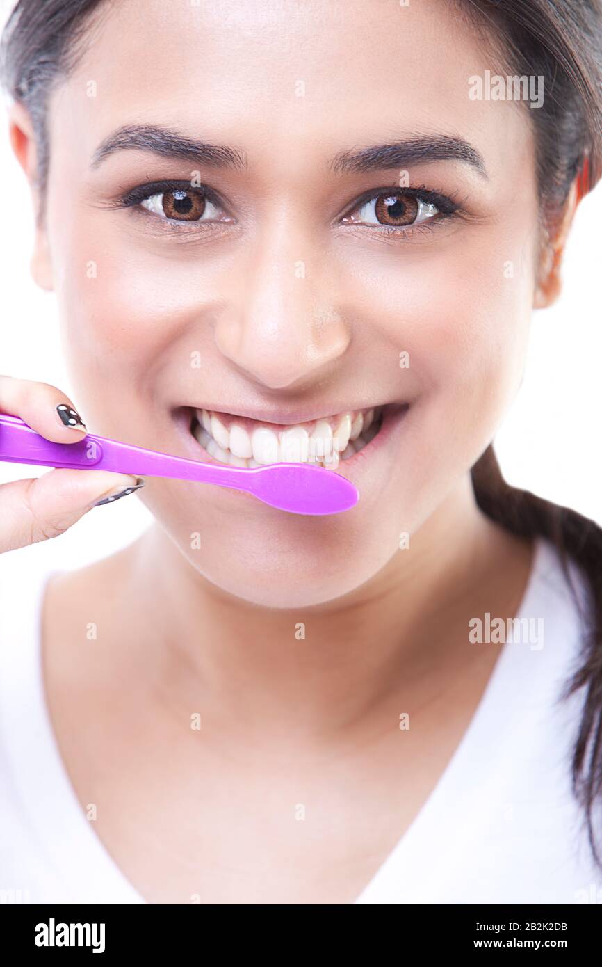Pretty Indian Model brushing her teeth with toothbrush Stock Photo Alamy