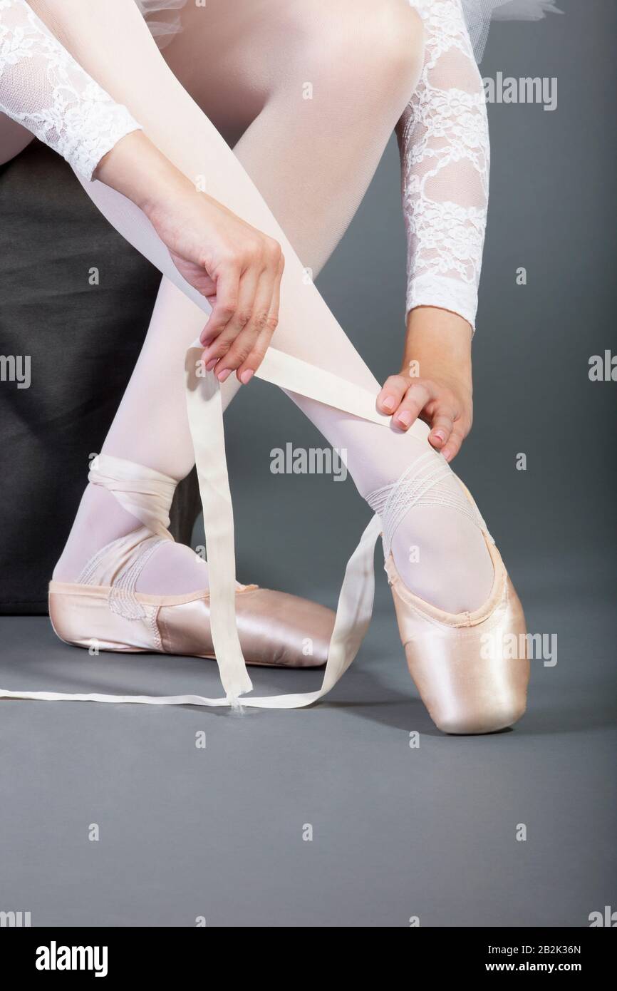 Low section of female ballet dancer tying pointe shoes Stock Photo Alamy