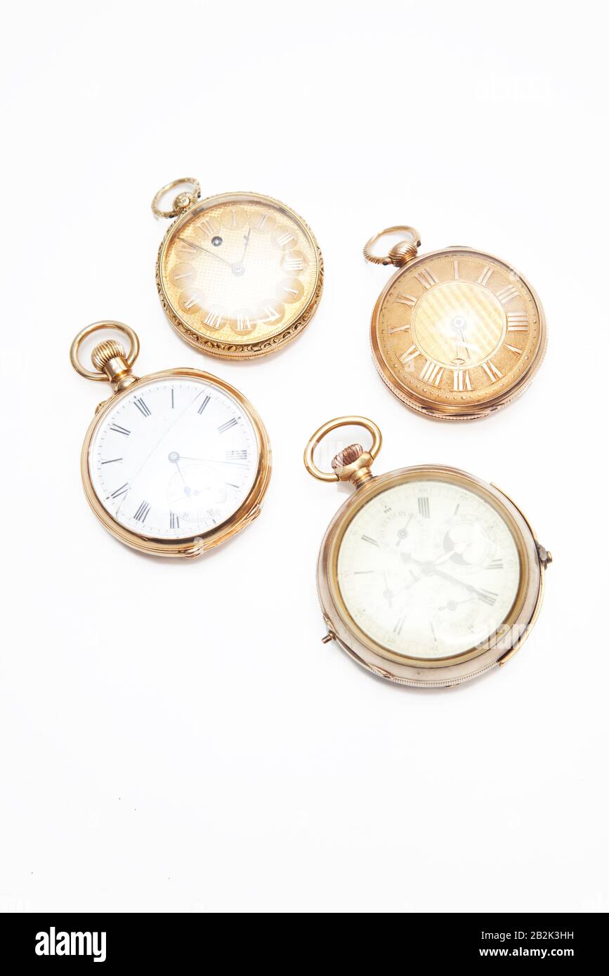 Four oldfashioned pocket watches over white background Stock Photo Alamy