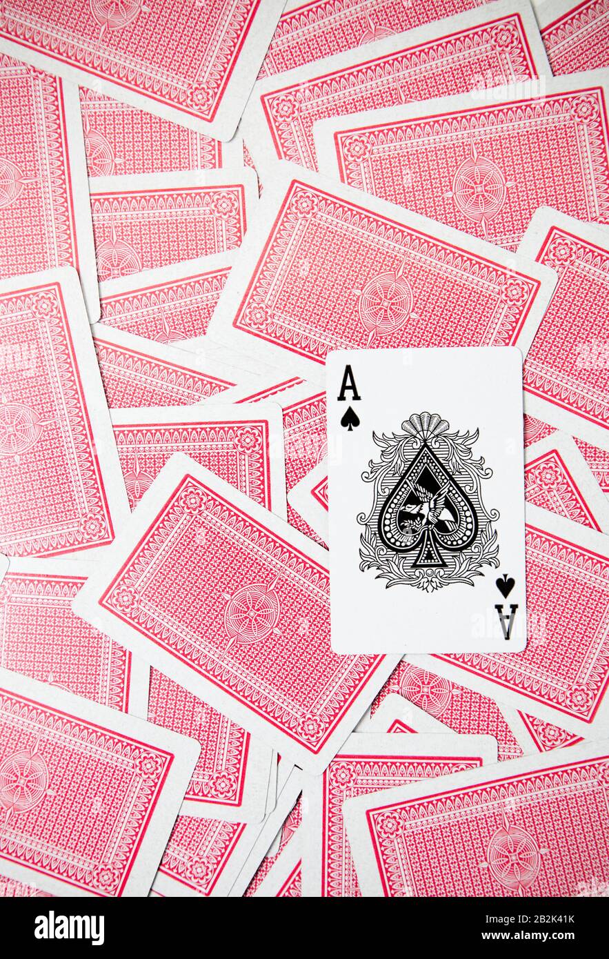 Ace of Spades sitting on top of red backed cards Stock Photo