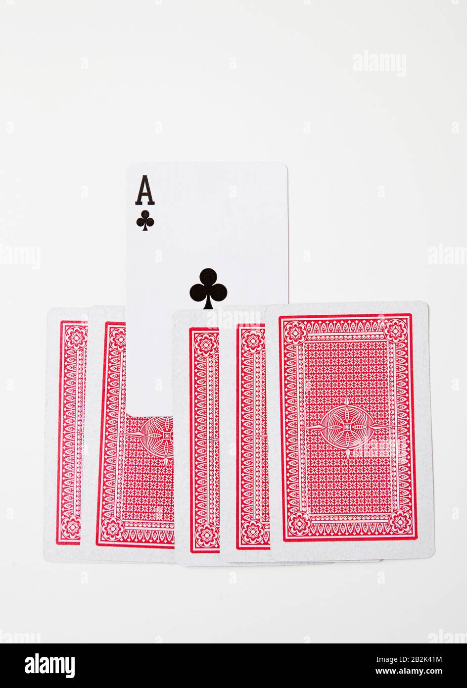 Ace of clubs standing out from other red cards Stock Photo