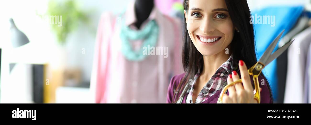 Professional seamstress in maroon blouse Stock Photo