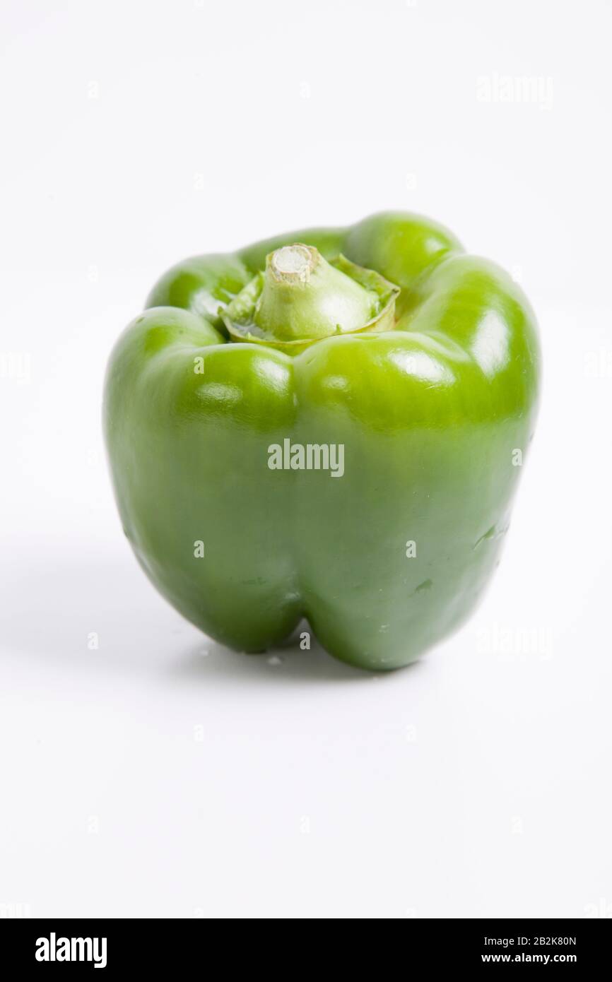 Close-up of green bell pepper over white background Stock Photo