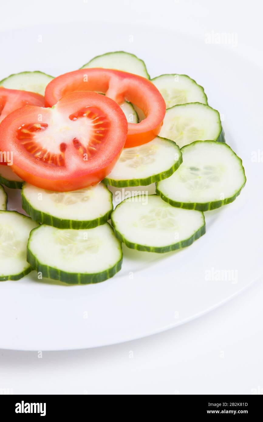 Close-up  of sliced tomatoes and cucumbers in plate Stock Photo