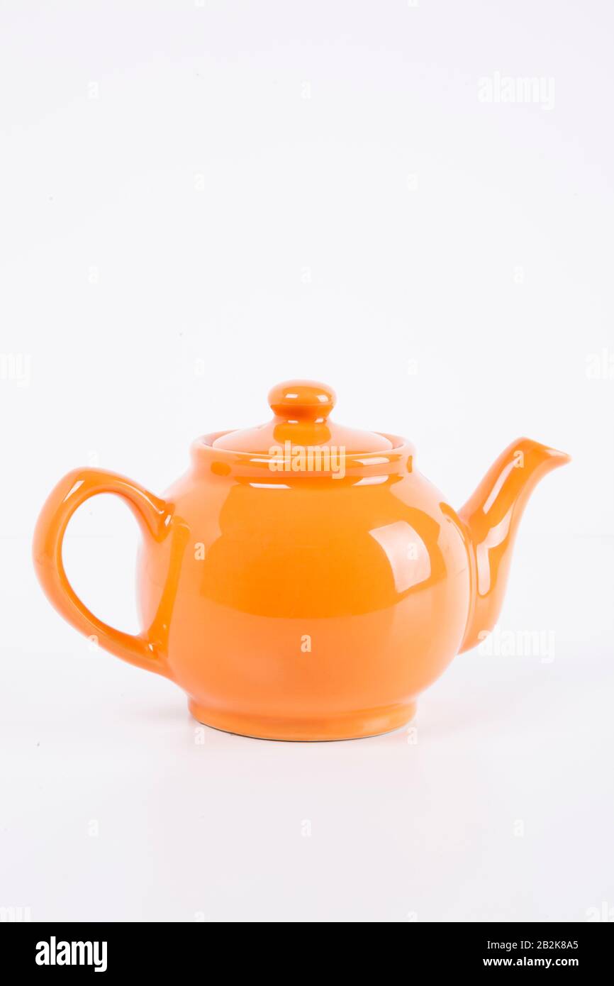 Close-up of orange kettle over white background Stock Photo