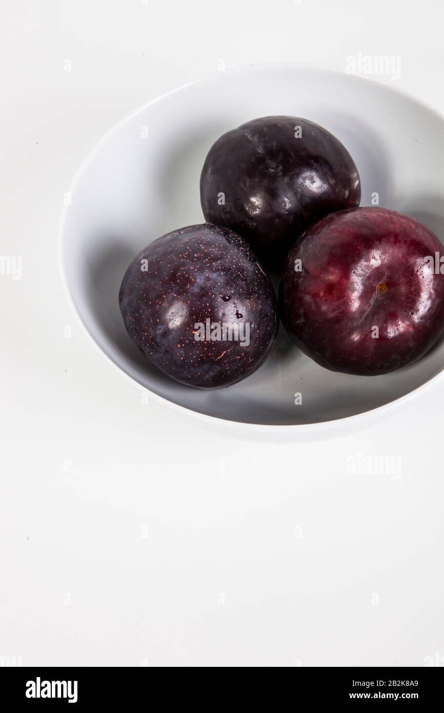 Close-up of plums in bowl Stock Photo