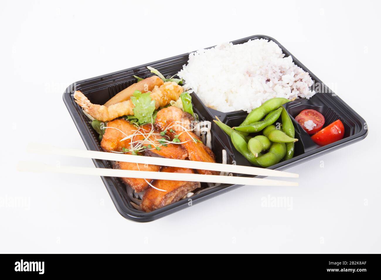 Healthy food served in tray with chopsticks over white background Stock Photo