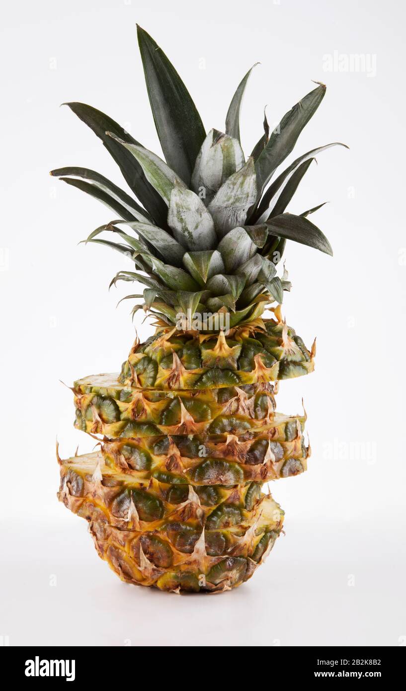 Pineapple cut in slices over white background Stock Photo