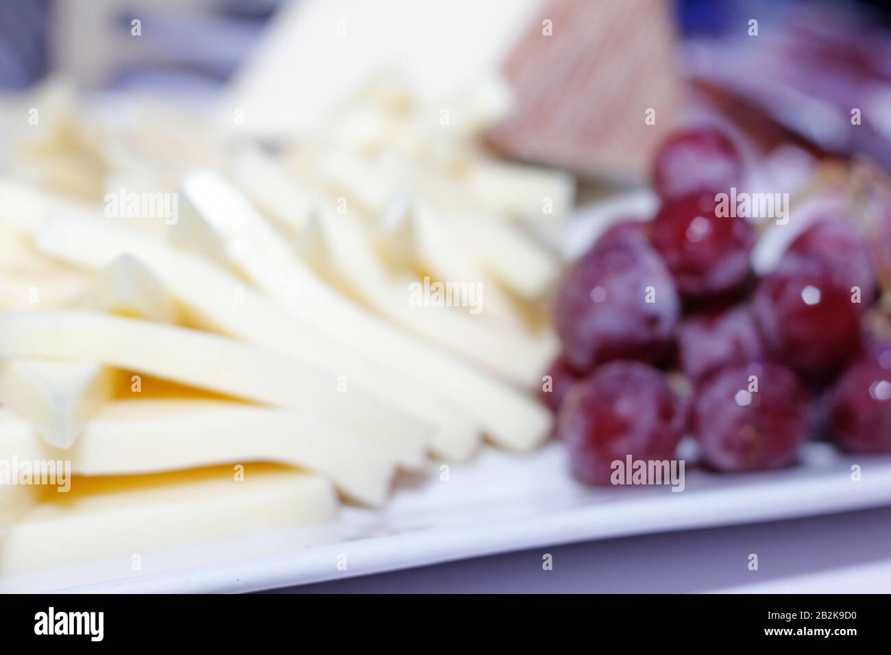 Trays full of slices of cheese served at the buffet Stock Photo