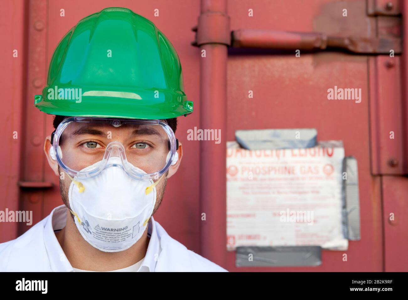Worker in hazmat suit, hard-hat and face mask Stock Photo