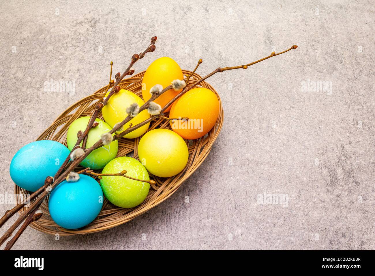 Easter eggs concept willow seals branches in a wicker basket. On a