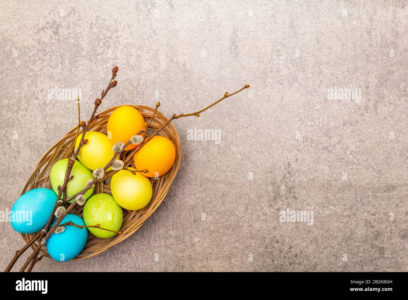 Easter eggs concept willow seals branches in a wicker basket. On a