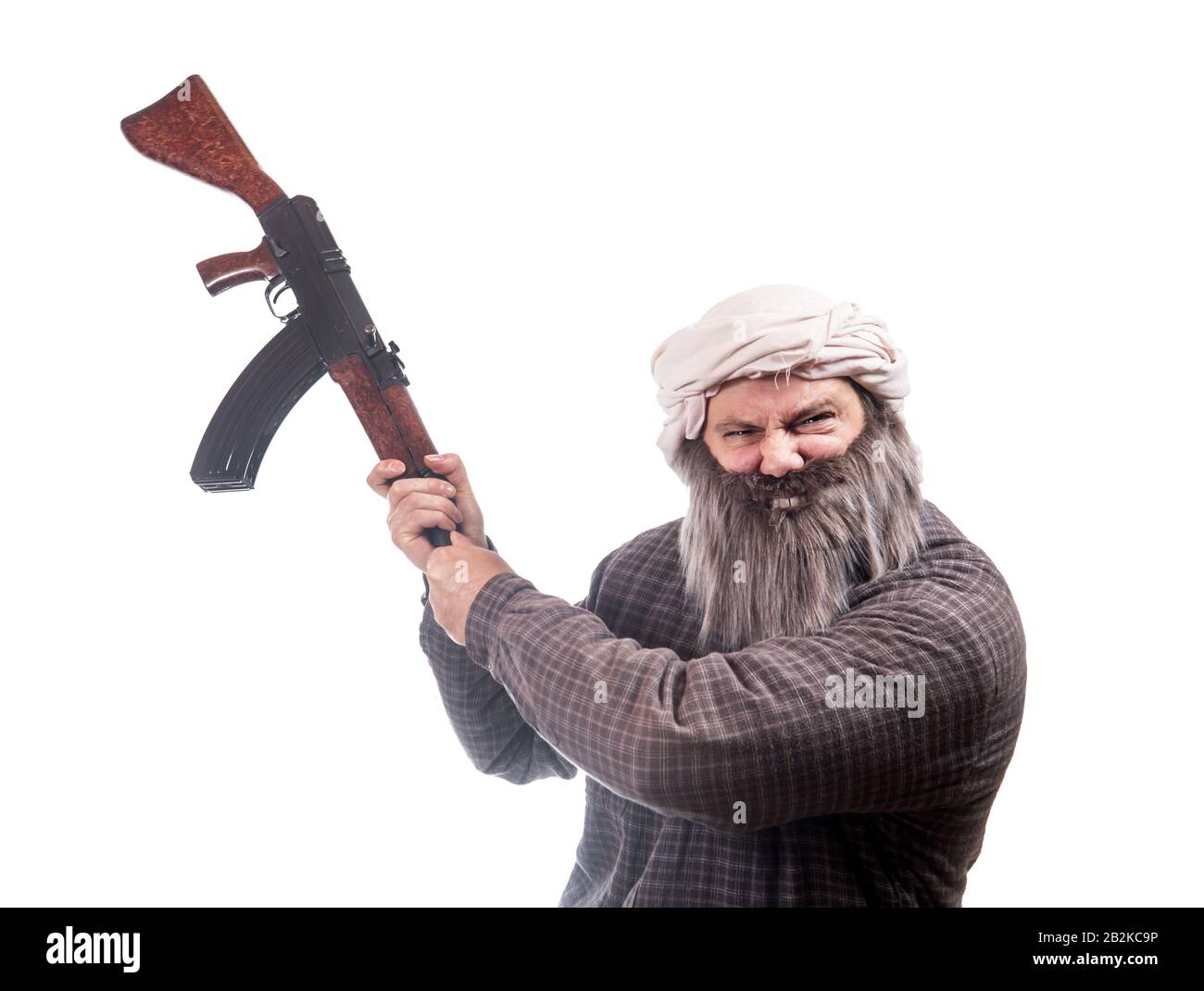 The bearded man attack with kalashnikov isolated on a white background. Emotional warrior wants to hit enemy with automatic weapon. Stock Photo