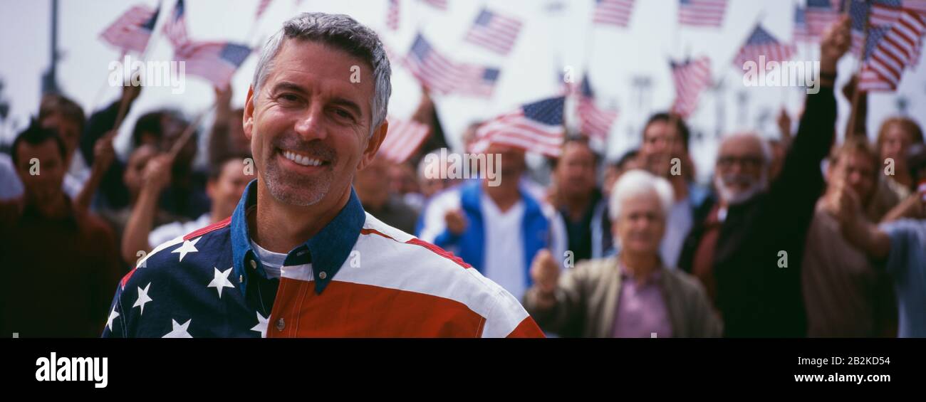 Portrait of happy mid-adult man with crowd celebrating Independence Day(USA) Stock Photo